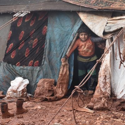 IDLIB, SYRIA - JANUARY 15:  A child looking out of tent surrounded by mud at Al-Ihsan refugee camp as Syrians enduring harsh winter at the camp in Idlib, Syria on January 15, 2019. 
 (Photo by Muhammed Abdullah /Anadolu Agency/Getty Images)